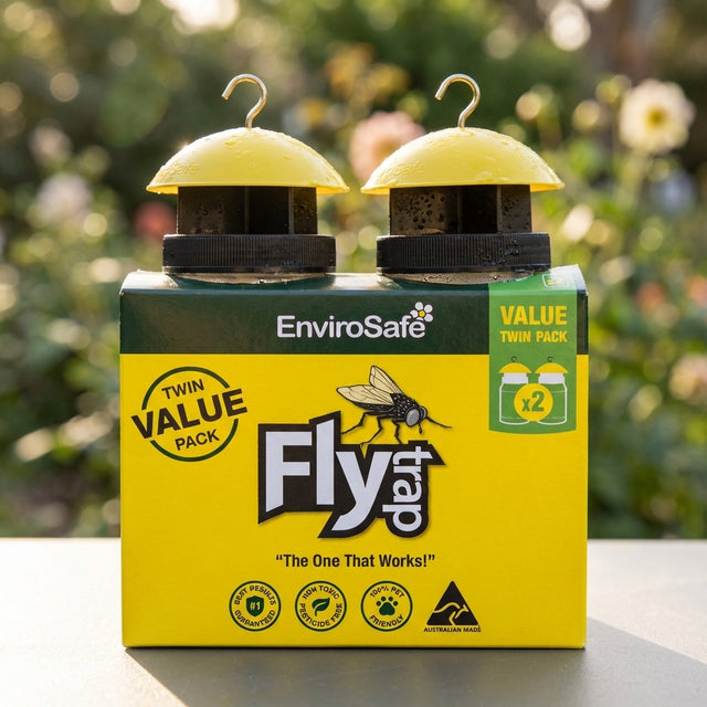 EnviroSafe Fly Trap - 2 Pack, a chemical-free fly control solution in yellow-green packaging, shown outdoors with a blurred garden background.
