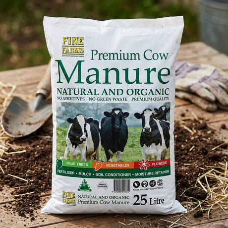 A Fine Farms 25L Cow Manure bag rests on a wooden surface next to a garden trowel.