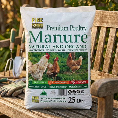 A 25L bag of Fine Farms Poultry Manure organic fertiliser sits on a wooden bench among gardening tools, featuring vibrant chickens on its design.