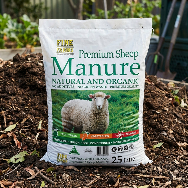 A 25L bag of Fine Farms Sheep Manure, a great organic soil conditioner, rests on a garden compost pile.