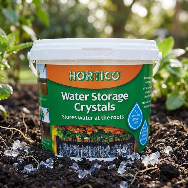 A 500g tub of Hortico Water Storage Crystals on soil in a garden, surrounded by clear crystals—ideal for gardening and boosting water retention.