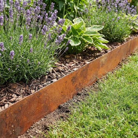 The Jack 1180mm x 200mm Garden Edging Strip separates a garden bed with lavender and hostas from a grassy lawn, creating a clean, defined border.