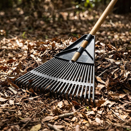 The Plastic Leaf Rake is an essential garden tool made in Australia, perfect for gathering brown dry leaves outdoors.