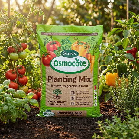 A bag of Scotts Osmocote Plus 25L Tomato, Vegetable & Herb Premium Planting Mix in a garden with healthy tomatoes, peppers, and herbs growing nearby.