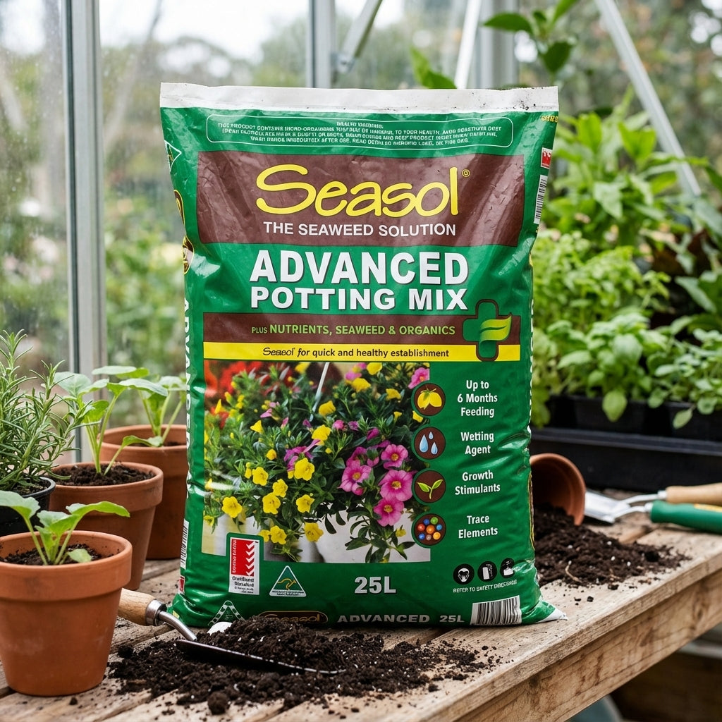 A 25L bag of Seasol 25L Advanced Potting Mix with slow-release nutrients is on a potting bench next to potted plants and gardening tools.