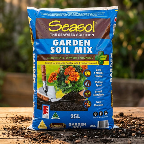 A Seasol 25L Garden Soil Mix bag, a premium blend with slow-release fertiliser, is displayed on a wooden surface with scattered soil outdoors.