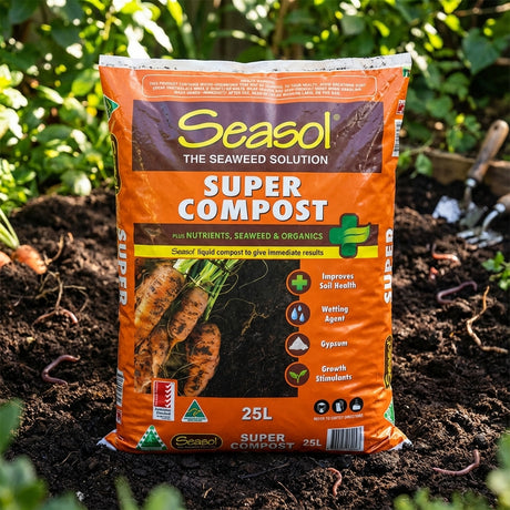 A 10kg bag of Richgro Ezi-Wet Soil Soaker sits on garden soil among plants and tools, improving water penetration to promote healthier plant growth.