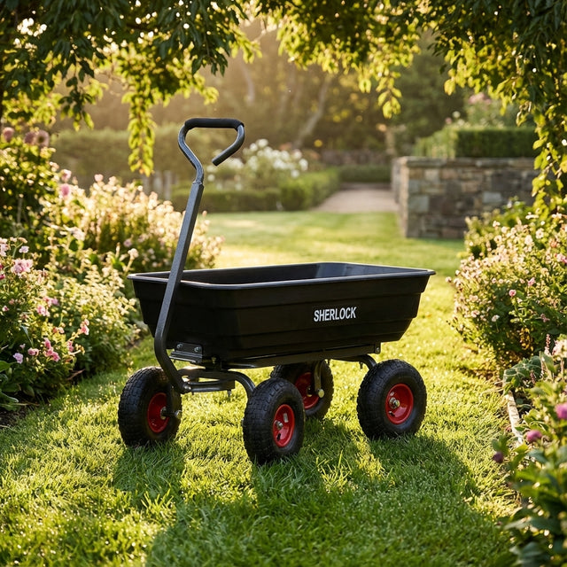 A Sherlock Black Poly Cart - 67 Litres, featuring a sturdy poly tray and red wheels, rests on a grassy path bordered by blooming flowers.