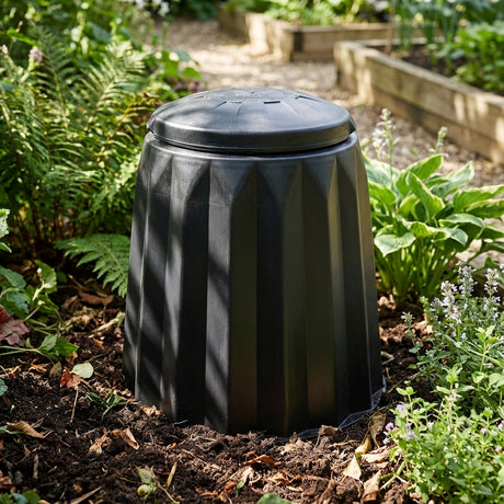 The Tumbleweed 220L Gedye Compost Bin is ideal for gardens, promoting easy and efficient composting among lush greenery when placed directly on soil.