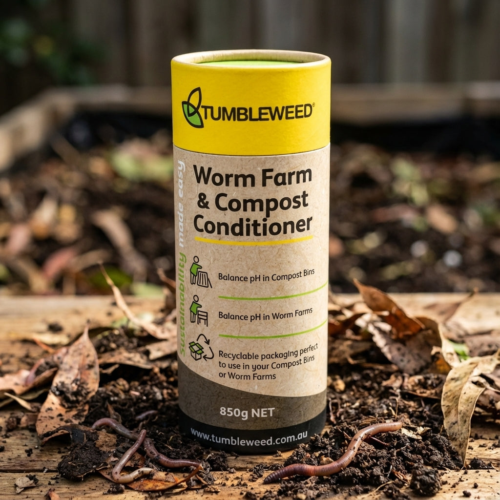 Tumbleweed Worm Farm And Compost Conditioner rests on soil with earthworms and dry leaves, helping maintain a healthy pH balance in your worm farm.
