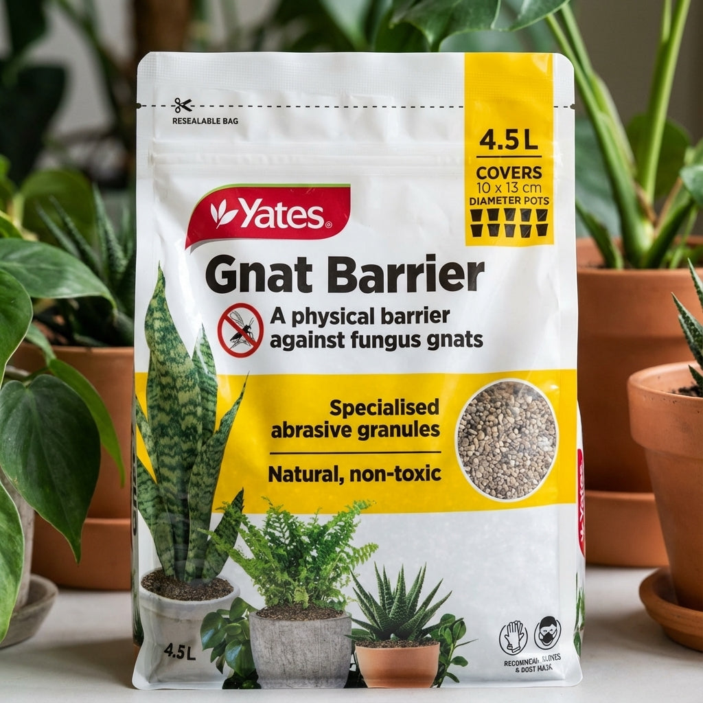 A bag of Yates 4.5L Gnat Barrier sits among potted plants, highlighting its natural pumice granules for effective fungus gnat control.